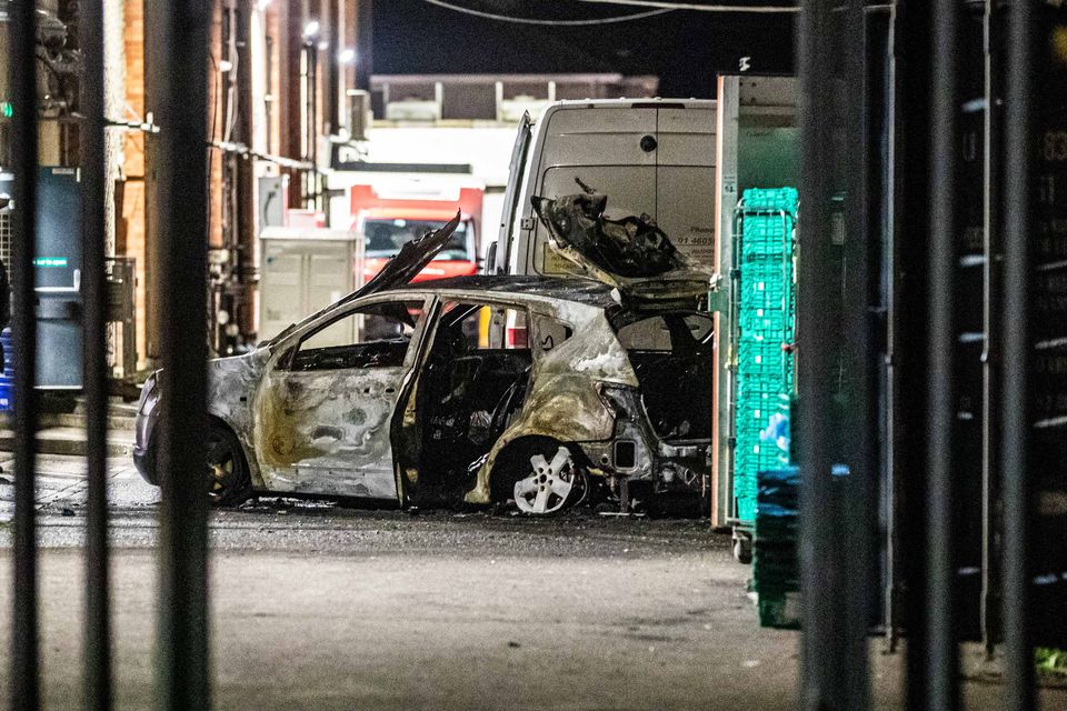 A burnt out car sits next to a cash-in-transit van behind Lucan Shopping Centre while Gardaí investigated the scene. Photo: Damien Storan.