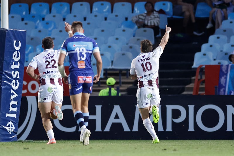Bordeaux Begles's Mathieu Jalibert (R) celebrates after scoring a try during the pool 4 round 1 European Rugby Champions Cup match between the Bulls and the Bordeaux Begles at the Loftus Versfeld Stadium in Pretoria, on December 6, 2025. (Photo by EMMANUEL CROSET / AFP via Getty Images)