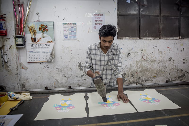 A man working in a garment printing factory in Dhaka, Bangladesh