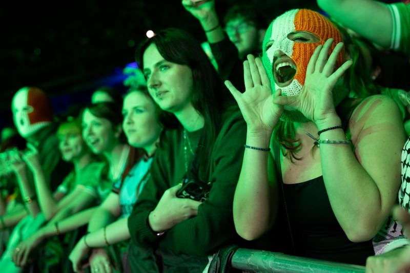 A Tricolour balclava-clad fan reacts during the gig. Photograph: Chris Maddaloni