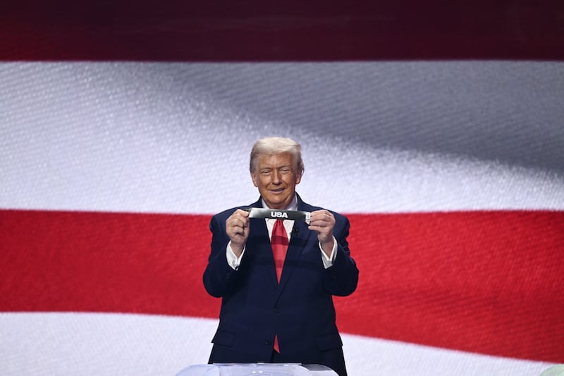 US president Donald Trump shows the card reading USA during the draw for the 2026 FIFA Football World Cup. Photograph: Brendan Smialowski/ AFP via Getty Images