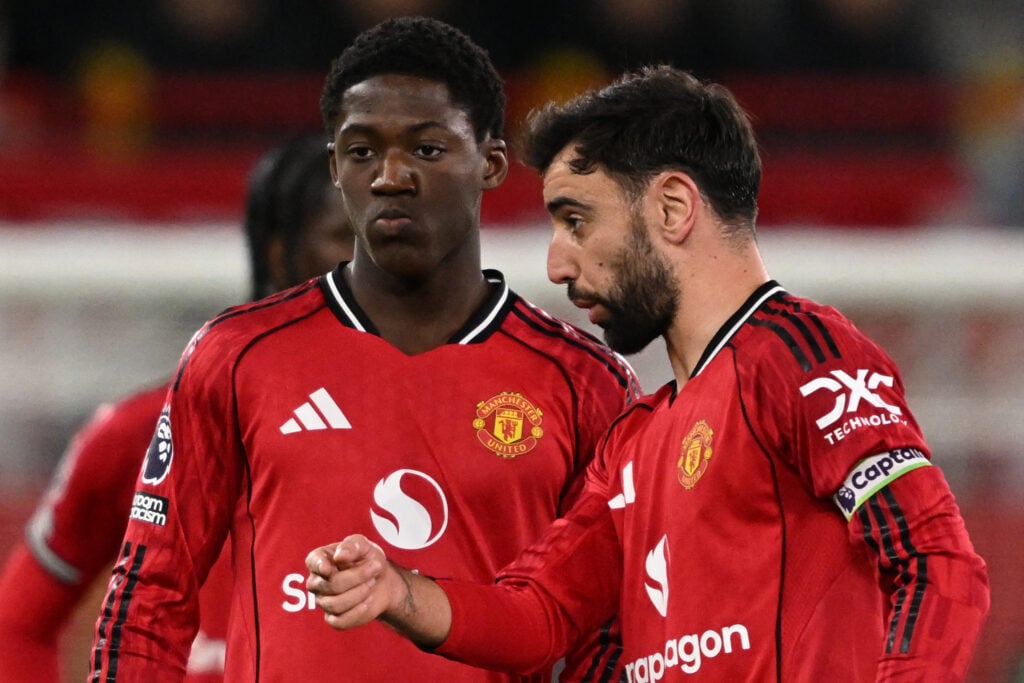 Bruno Fernandes talks with Kobbie Mainoo during the Premier League match between Manchester United and Bournemouth at Old Trafford in Manchester, England, in 2025.