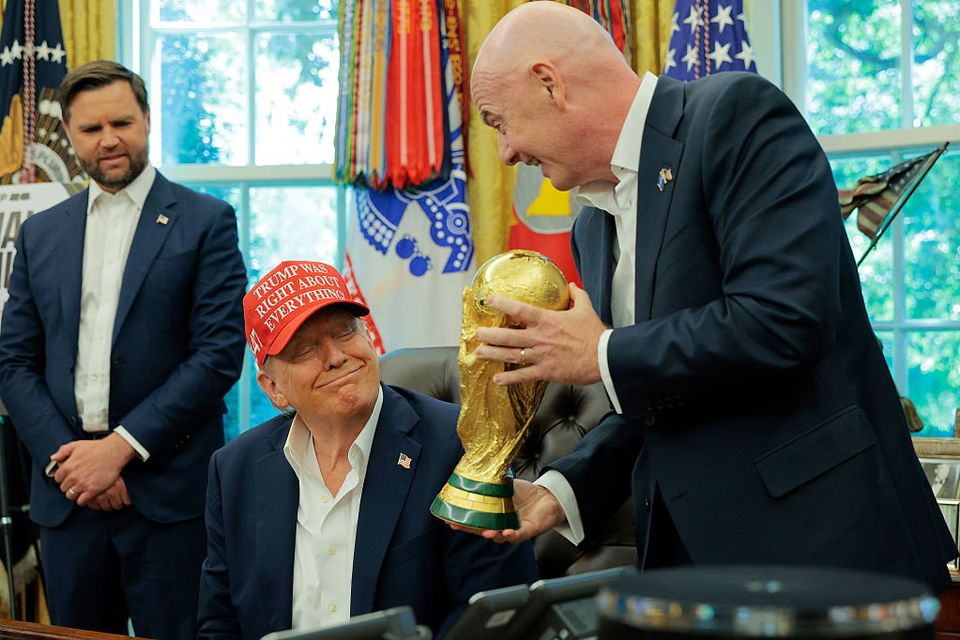 FIFA President Gianni Infantino shows U.S. President Donald Trump the World Cup Trophy in the Oval Office as Vice President JD Vance looks on. (Photo by Chip Somodevilla/Getty Images)
