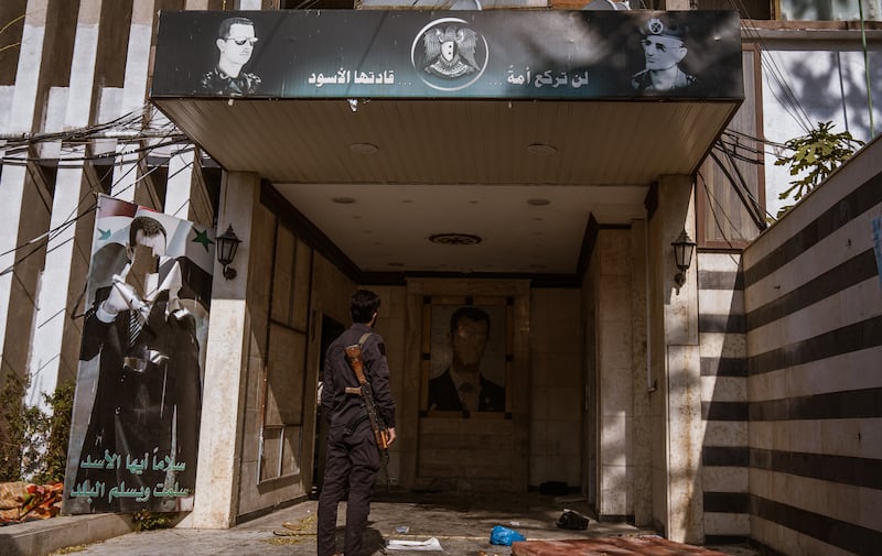 Portraits of Hafez al-Assad and his son Bashar al-Assad at a notorious torture and intelligence centre in Damascus, Syria. Photograph: Emin Sansar/Anadolu via Getty Images