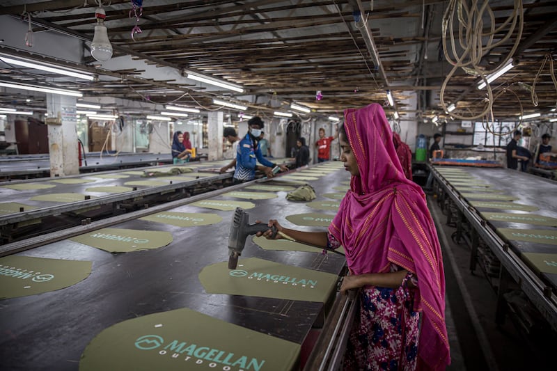 Eti and garment workers pictured in a clothing printing factory in Dhaka, Bangladesh.