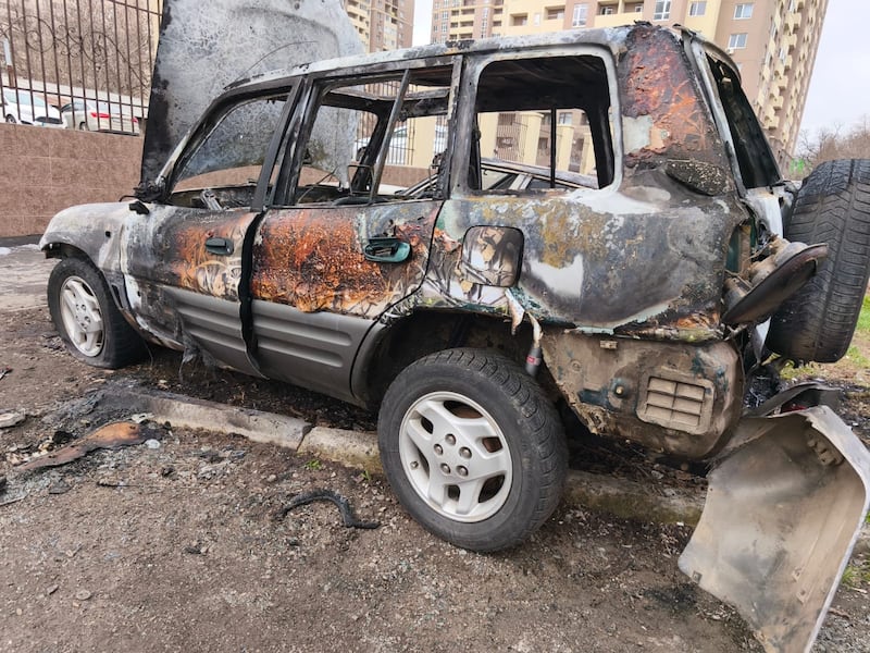 Serhiy Komarenko's family car after it was torched four months ago in Odesa. The car had a camouflage paint job, and the teenage perpetrator had agreed to take money to set a 'military vehicle' on fire. The recruiter is believed to have been working for Russia. Photograph: Courtesy of Serhiy Komarenko