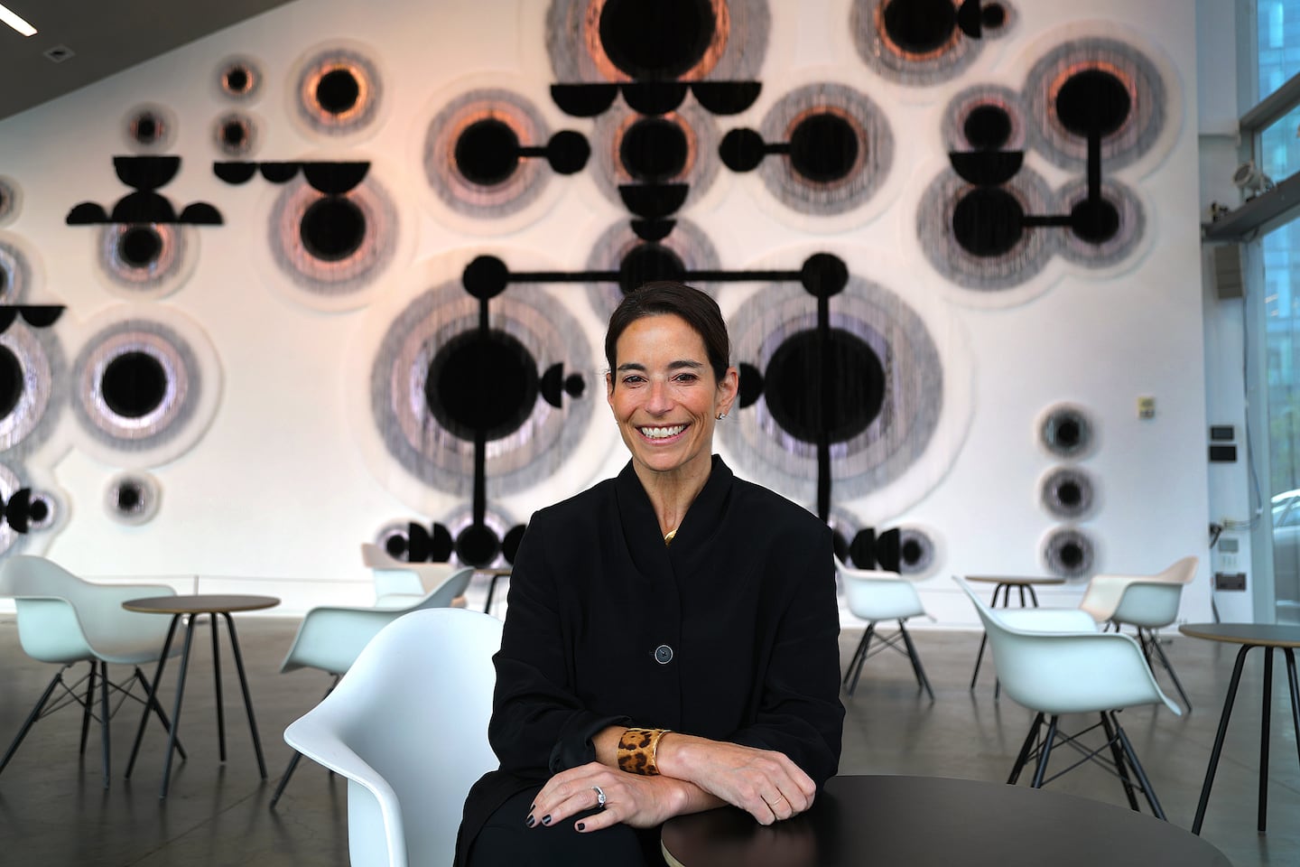 Nora Burnett Abrams is the Institute of Contemporary Art’s new director. She sits in the lobby in front of an installation by Caroline Monnet called "Man-made Land."