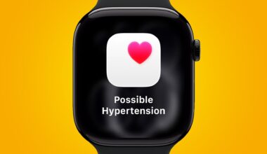 An Apple Watch displaying a hypertension alert in watchOS 26.