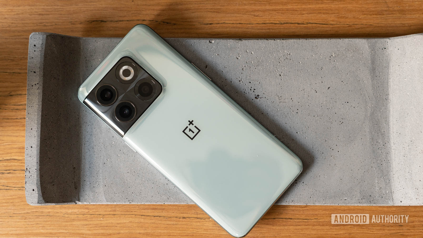 OnePlus 10T placed on a concrete slab OnePlus 10T placed on a concrete slab