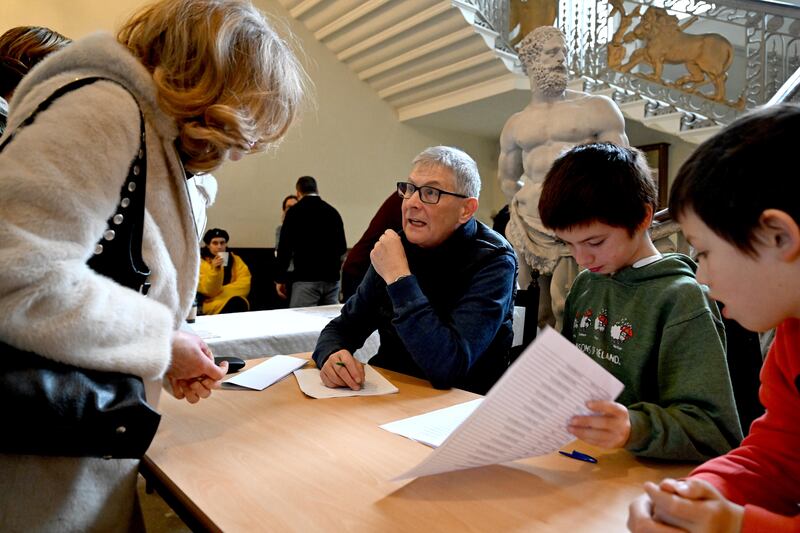 Joe McEvoy registering volunteers, with Zhang Mao Maguire aged 10 and Kai Zhang Maguire aged 8 from Stillorgan. Photograph: Bryan Meade