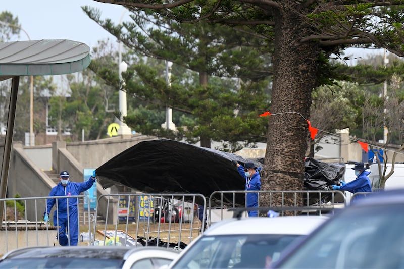 Police and forensic experts inspect the scene of a shooting at Bondi Beach  in Sydney, Australia.  Photograph: Izhar Khan/Getty Images