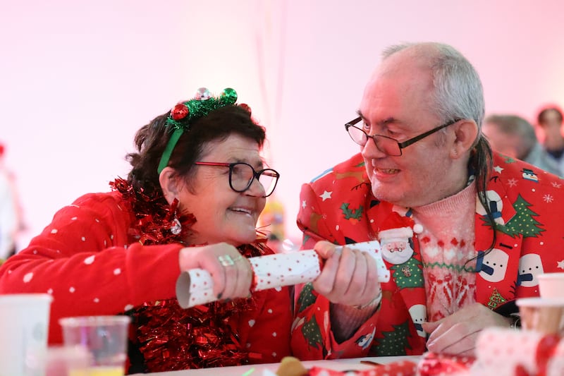 Siblings Maria and James Byrne pull a cracker at the RDS Christmas dinner. Photograph: Bryan O’Brien
