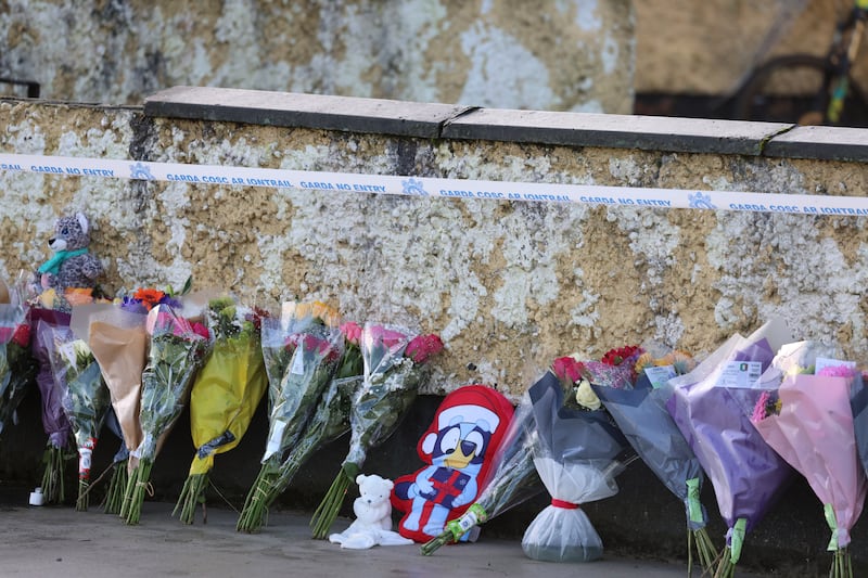 Flowers left along the garden wall outside the house on Monday. Photograph: Dara Mac Dónaill