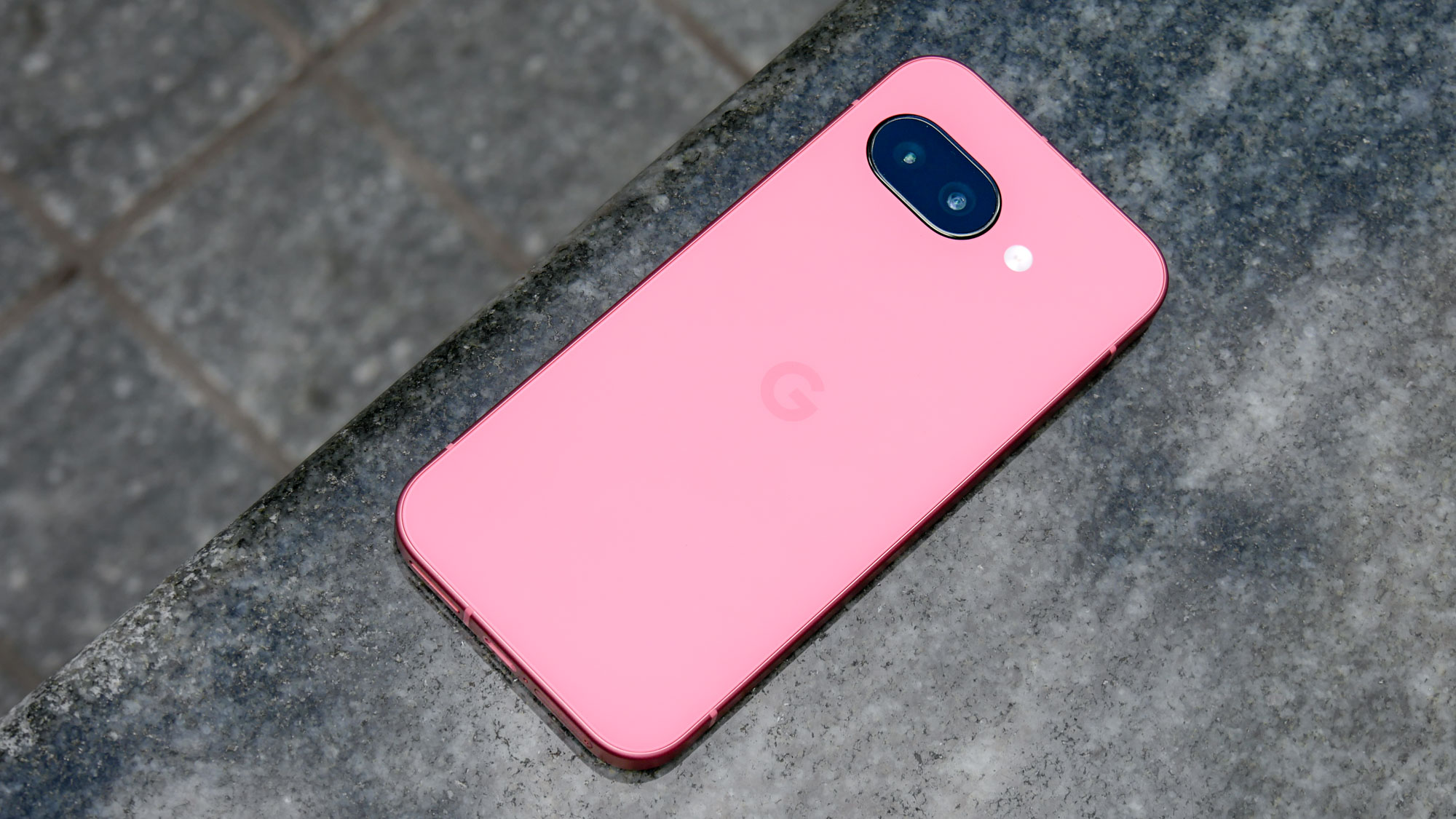 Google Pixel 9a held in the hand.