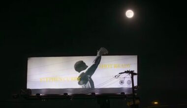 A billboard at night shows a black-and-white image of a basketball player shooting, with the words "STEPHEN CURRY" and "SHOT READY." A full moon glows above the billboard in the dark sky.