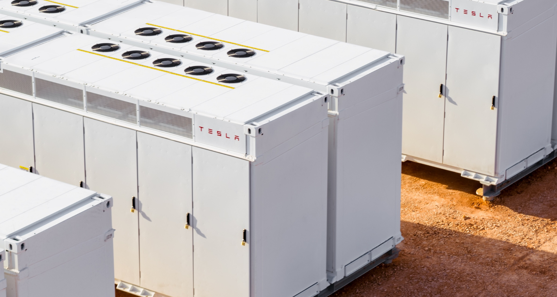 A Tesla Megapack cluster deployed in a desert environment.