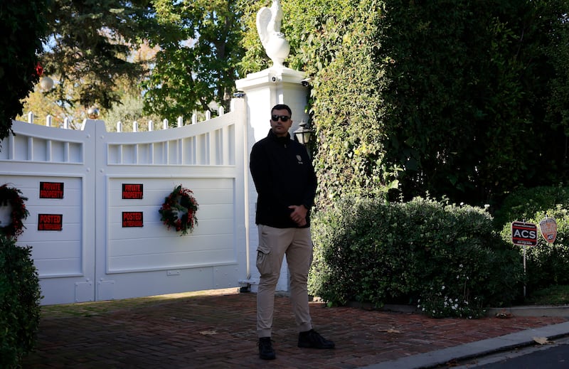A security guard keeps watch in front of director Rob Reiner's home in Brentwood, California. Photograph: Mario Tama/Getty Images