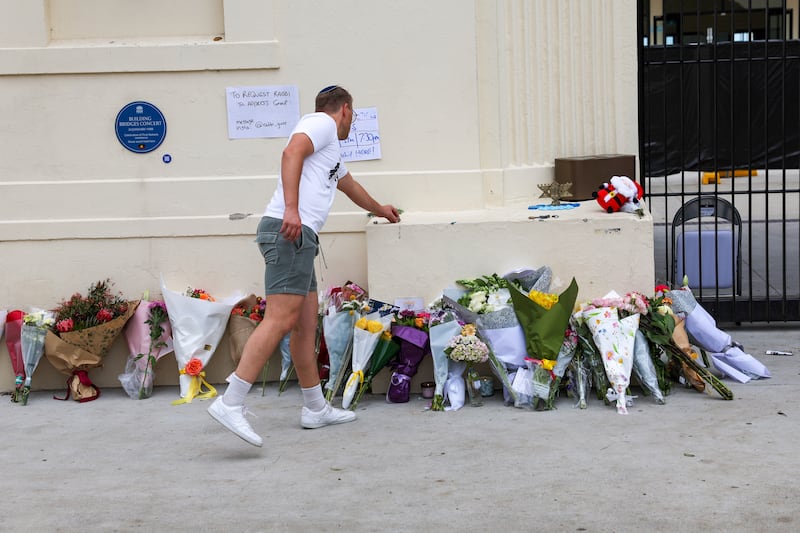 A mourner pays tribute at a memorial that has recently been cleared at the Bondi pavilion at Bondi Beach on December 22nd, 2025 in Sydney, Australia. Photograph: Izhar Khan/Getty Images
