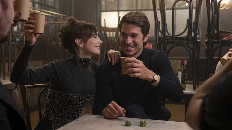 Gabriel toasting with Emily and other chefs on Emily in Paris