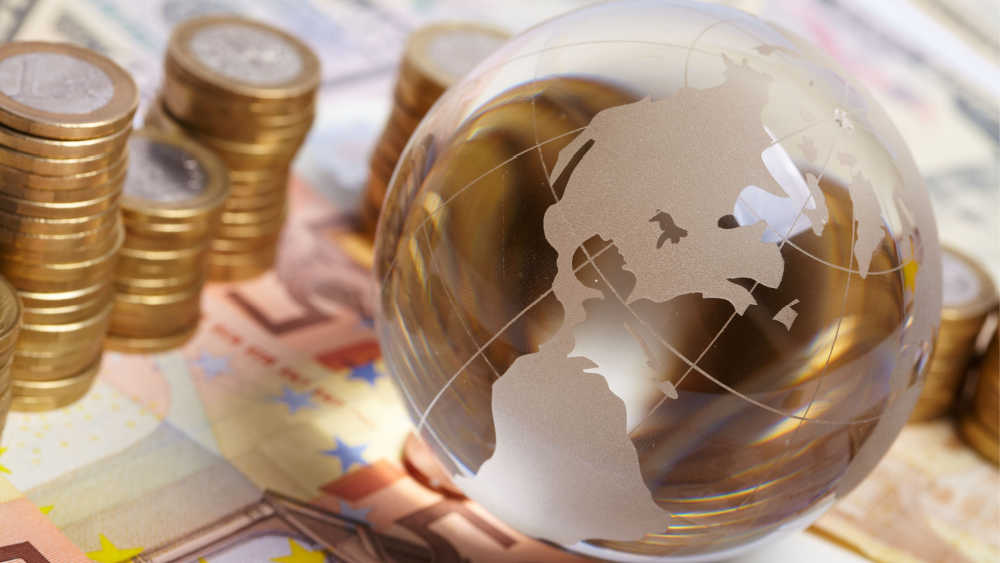 A glass globe and euro notes.