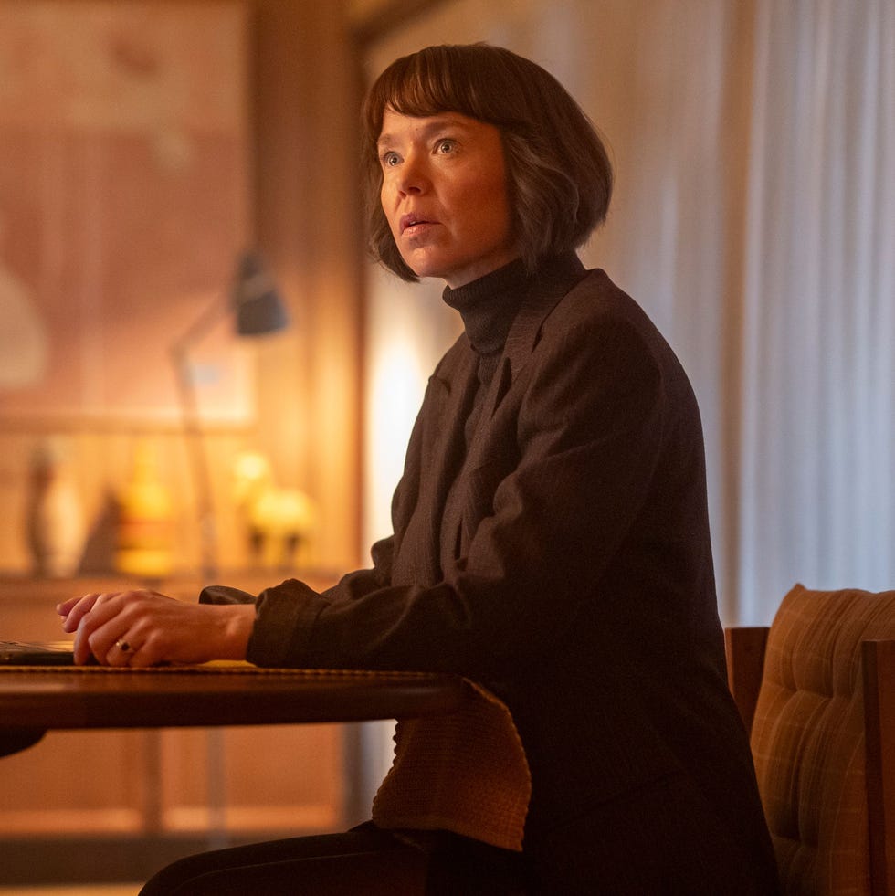 person using a laptop at a wooden table in a cozy interior person using a laptop at a wooden table in a cozy interior