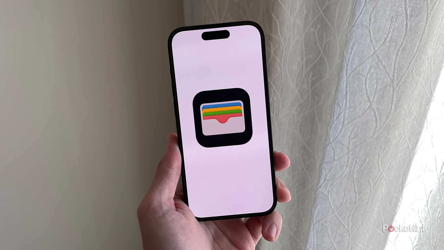 Apple Wallet in front of majestic curtains.