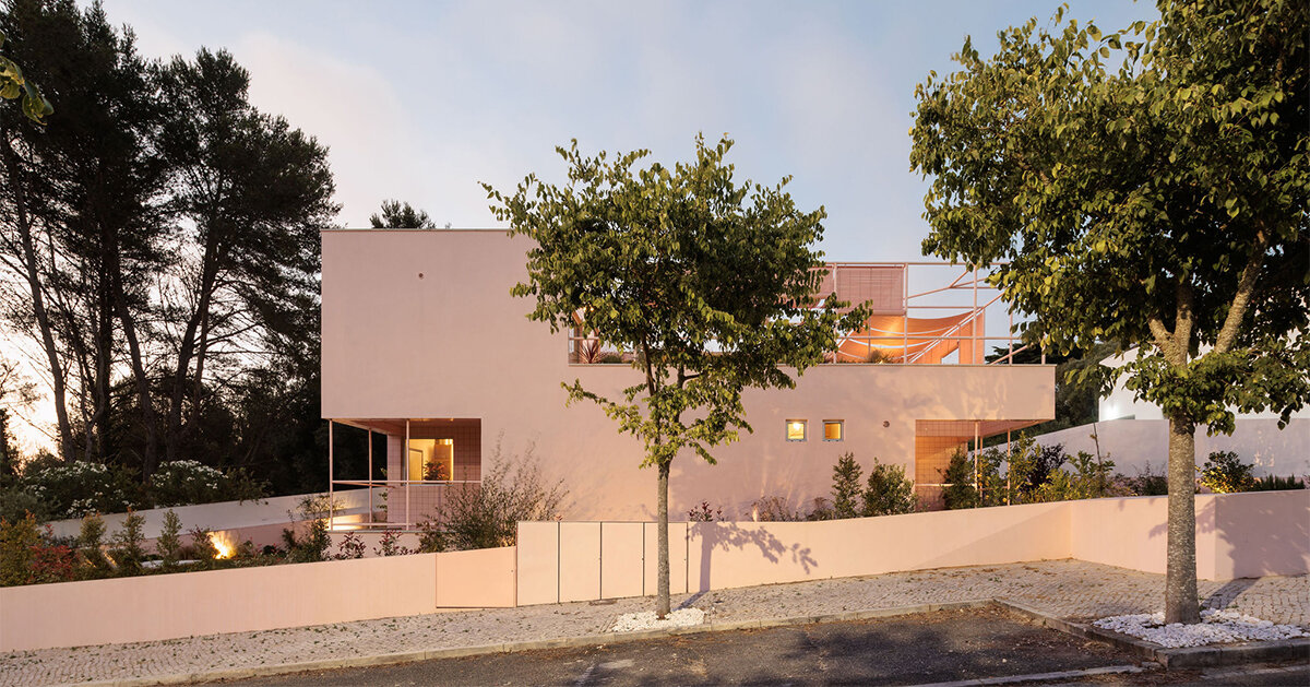 atelier RUA's pink house contrasts with its surroundings in portugal