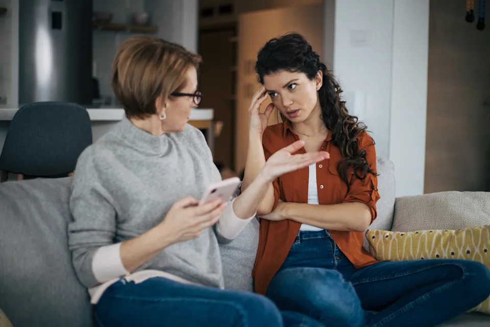 Mother and daughter arguing on the couch