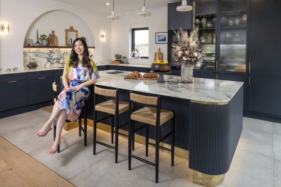 Businesswoman Vivian Wong in the kitchen she designed with her husband Philip McKendry. They put in the arch over the sink and added more windows. Photo: Tony Gavin
