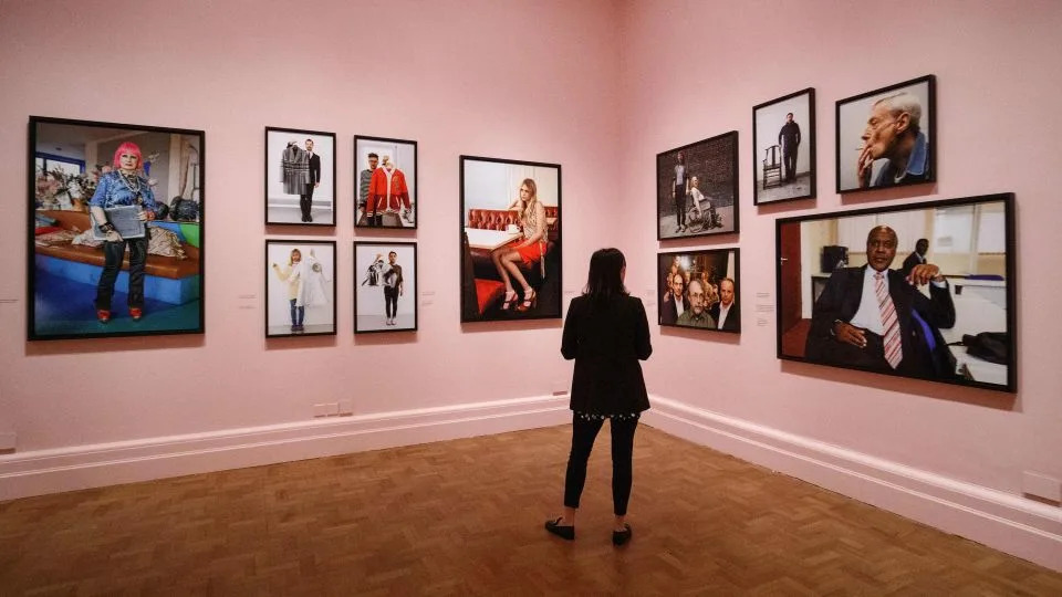 A selection of Parr's photographs on show during his 2019 exhibition "Only Human: Photographs by Martin Parr" at the National Portrait Gallery in London. - Tolga Akmen/AFP/Getty Images