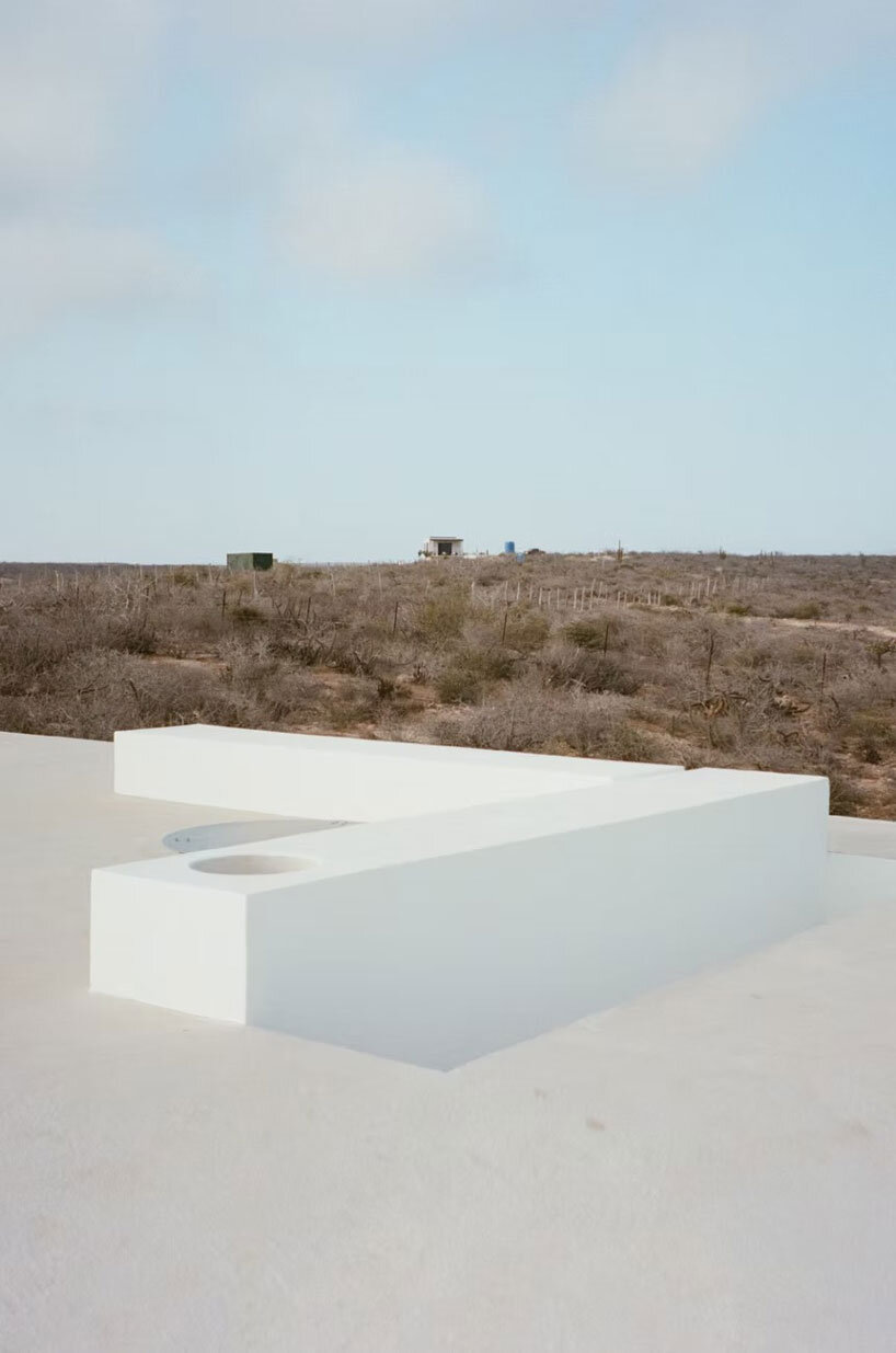 white louvers craft perforated facade filtering daylight within casa nada’s interiors in mexico