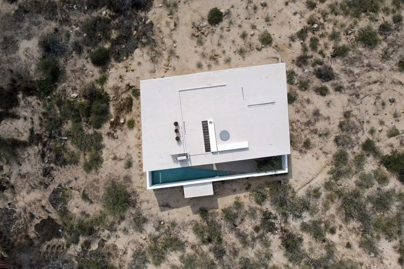 white louvers craft perforated facade filtering daylight within casa nada’s interiors in mexico