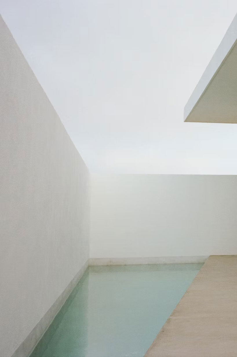 white louvers craft perforated facade filtering daylight within casa nada’s interiors in mexico