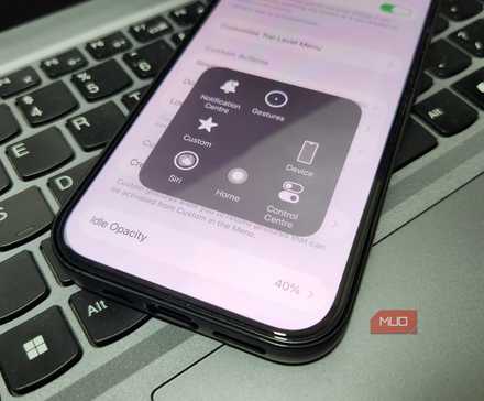Close up of iPhone on laptop keybaord showing AssistiveTouch