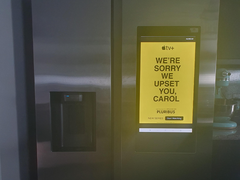 Pictured, the "We're sorry we upset you, Carol" advertisement on the Samsung smart refrigerator screen. (Image source: u/Shellnanigans via r/assholedesign)