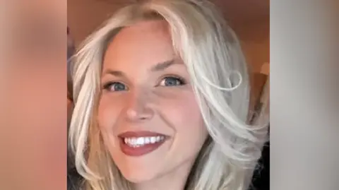 Facebook A woman smiles at the camera. It is a selfie and she has long blonde hair and blue eyes.