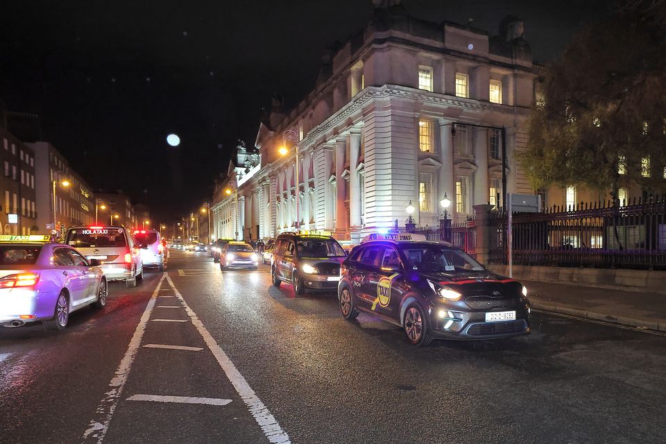 Taxi drivers make their way past Government Buildings near Merrion Square during a protest on Wednesday this week. Photo: Frank McGrath