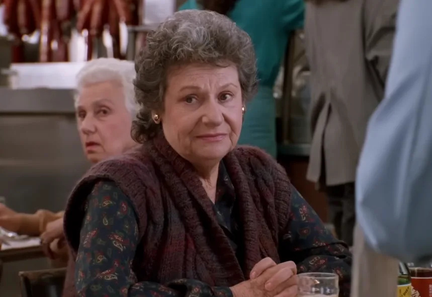 I don't know who these people are, but the image shows two older individuals sitting in a restaurant, appearing engaged in conversation