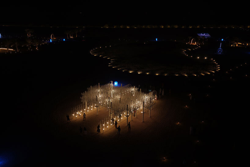 cloud-like white canopy of hanging vines emerges from abu dhabi’s arid landscape