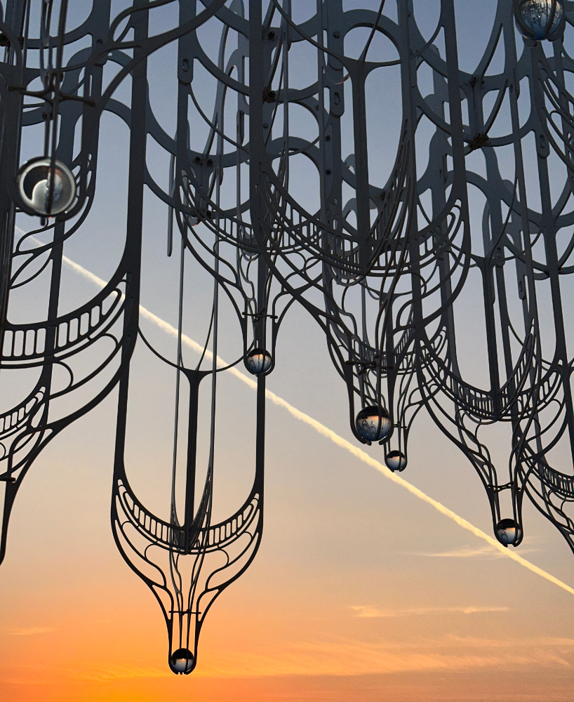 cloud-like white canopy of hanging vines emerges from abu dhabi’s arid landscape