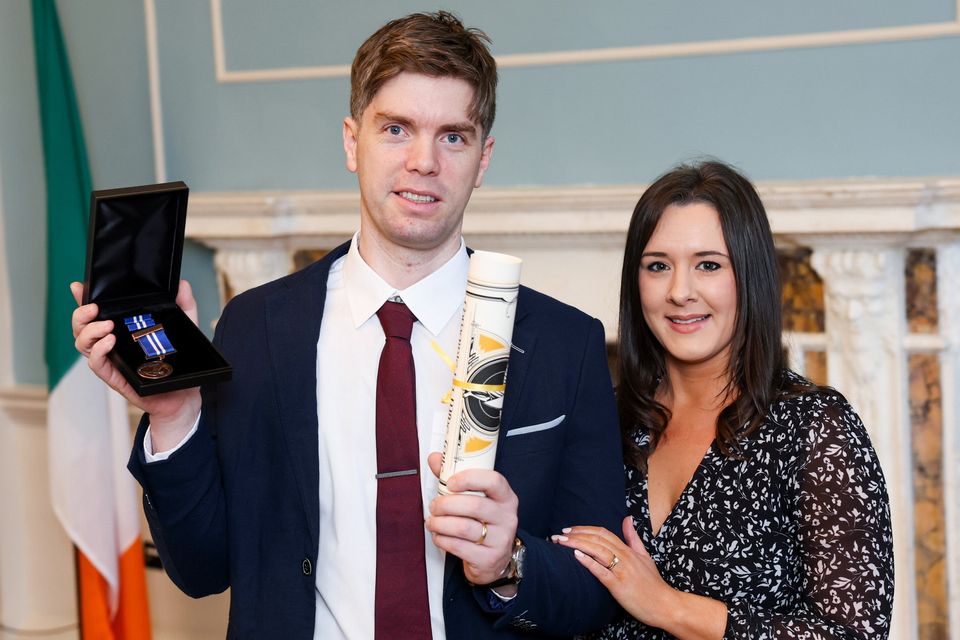 Sergeant Fergal O’Connor is awarded a bronze medal and a Certificate of Bravery for his actions at the National Bravery Awards 2025 with Jenny O'Connor. Photo: Maxwell’s