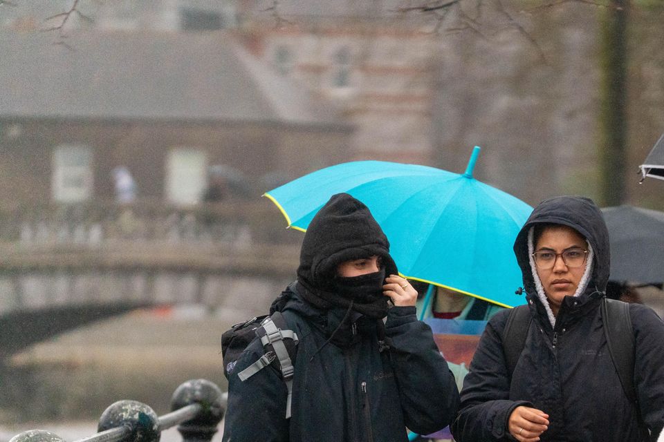 People shelter from the rain in Cork amid Storm Bram (Noel Sweeney/PA)