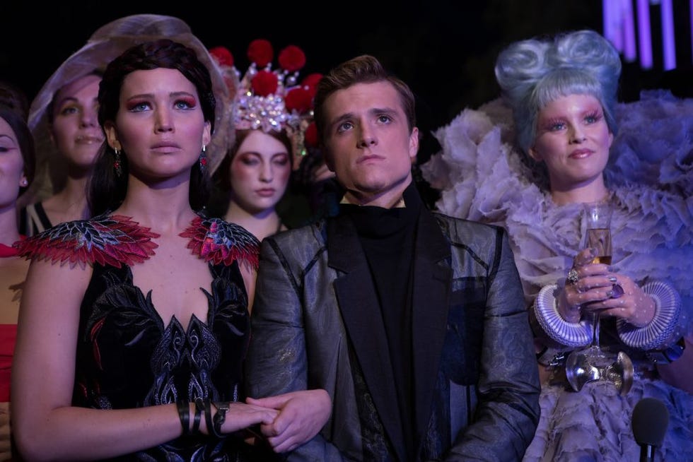 actors jennifer lawrence (l), josh hutcherson (m) and elizabeth banks on the set of the film the hunger games: catching fire, atlanta, usa, 2012. {photo by murray close/getty images}