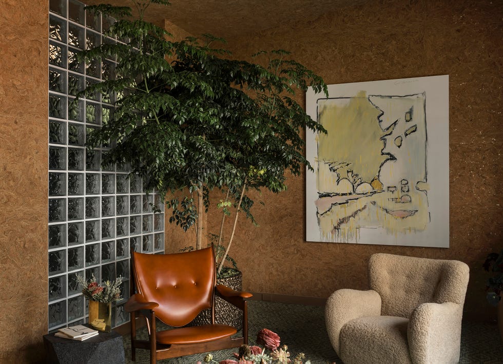 a warm toned room with a cubed glass wall.