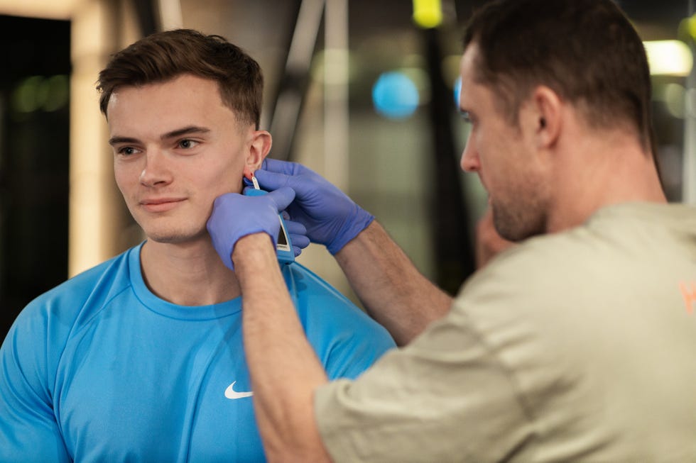 Receiving a lactate blood test during a VO2 max test on the treadmill receiving a lactate blood test during a vo2 max test on the treadmill