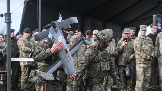 A Polish soldier carries an AI-powered antidrone system in Nowa Deba, Poland. Western sanctions have choked off Russia’s access to critical hardware.