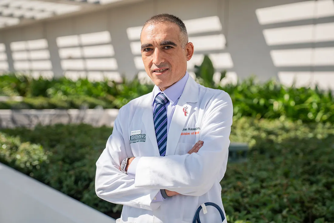 Dickran Kazandjian, M.D., in white clinic coat