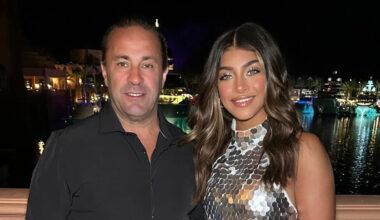 Joe Giudice and Gia Giudice smiling next to each other in front of a harbor.