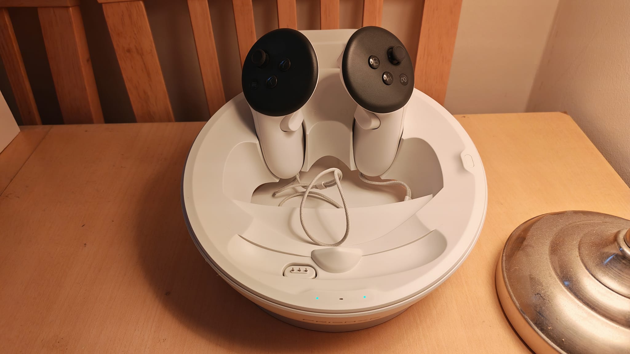 The PRismXR charging dock with the Quest 3 controllers cradled in it