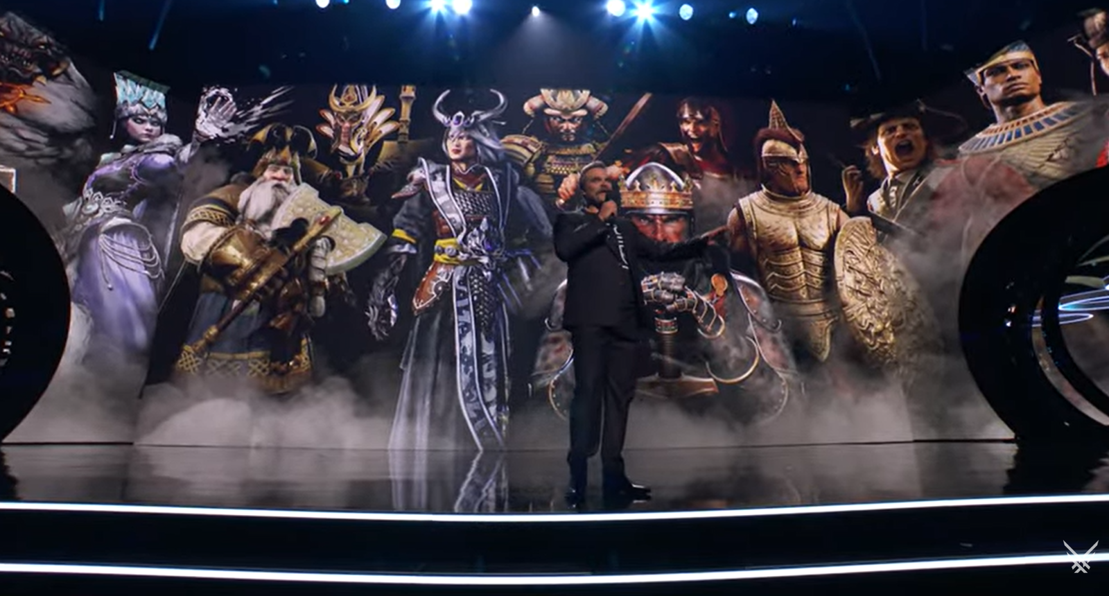 david harbour on stage in front of warhammer backdrop